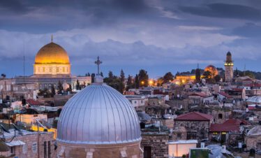 A panoramic view of the ancient city of Jerusalem, showcasing the iconic Dome of the Rock and historic stone walls.