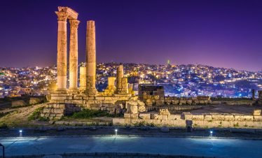 Experience Amman's rich history and vibrant culture on a Lionsgate Travel tour, featuring views of ancient ruins and modern cityscapes.