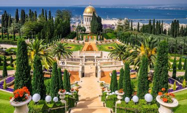 Explore the Bahá'í Shrine and Gardens in Haifa, Israel with Lionsgate Travel, showcasing its exquisite architecture and lush terraced gardens.