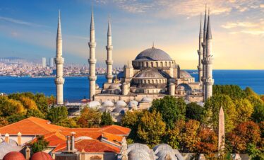 Panoramic view of Istanbul skyline showing the Hagia Sophia and Blue Mosque under a clear sky.