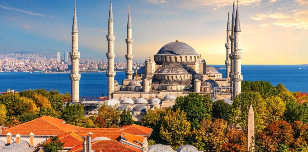 Panoramic view of Istanbul skyline showing the Hagia Sophia and Blue Mosque under a clear sky.