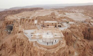 Aerial view of Masada's ancient fortress atop a rugged plateau overlooking the Dead Sea in Israel.
