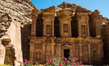 View of the Al Khazneh ('The Treasury') at Petra, Jordan, with its elaborate rock-cut architecture, under a clear sky, ideal for exploring ancient civilizations.